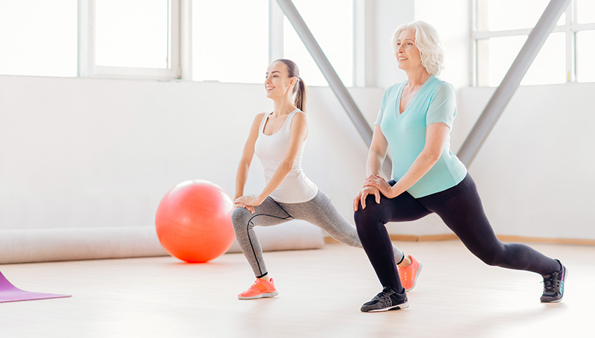 Two ladies stretching and exercising