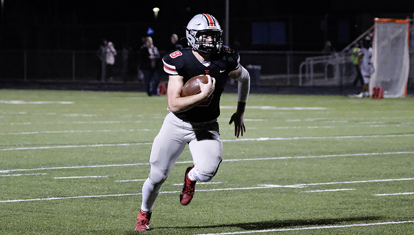 Zach Darche running with a football