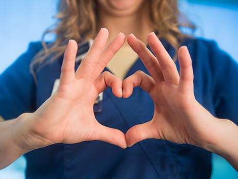 Nurse's hands in heart shape.