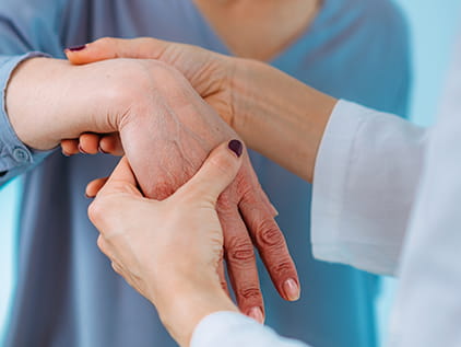 Doctor examining the hand of a patient suffering from carpal tunnel syndrome
