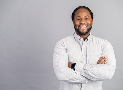 Man smiling with arms crossed over his chest